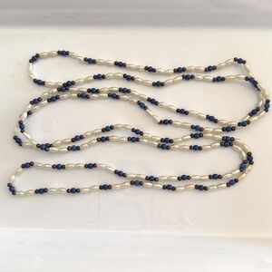 Beaded necklace. White, brown and blue beads 58” continuous. Claspless
